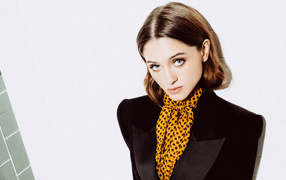 Actress Natalia Dyer in a black jacket on a white background