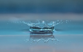 A drop of water breaks on the floor