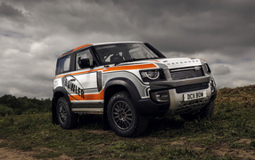 Large SUV Defender Challenge Car 2022 against a stormy sky