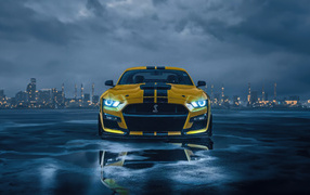 Yellow Ford Mustang sports car against a stormy sky
