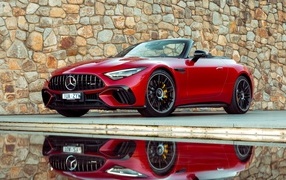 Red Mercedes-AMG SL 63 4MATIC+ 2023 against a wall