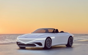 Белый автомобиль Genesis X  2023 года у моря