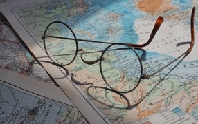 Glasses lies on the world map