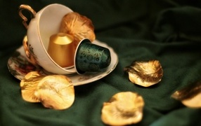 Golden petals and cup on the table