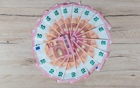 Circle of ten euro banknotes on the table