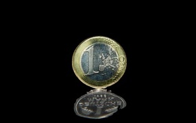 One euro coin on a black background