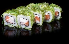 Appetizing rolls with fish on a black background