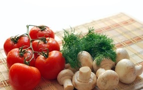 Champignons with tomatoes and dill on the table
