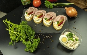 Delicious sandwiches with ham on the table with parsley