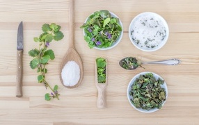 Fragrant herbs on the table with salt