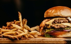 Juicy hamburger on the table with french fries
