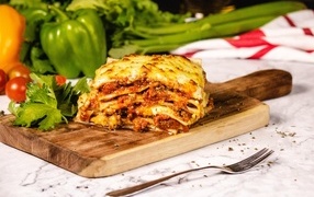 Lasagna on the table with vegetables