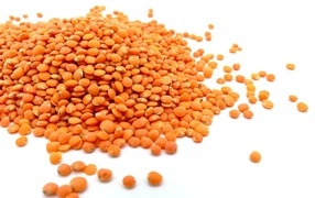 Orange lentils isolated on white background