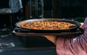 Paella dish in hands