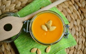 Pumpkin soup with wooden spoon