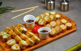 Rolls with soy sauce on a board on the table