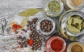 Spices in jars on a gray table
