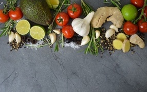 Vegetables, herbs and spices on a gray table