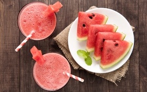 Slices of watermelon on the table with juice