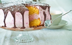 Cake with pink cream and chocolate on the table