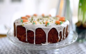 Carrot cake with icing on the table