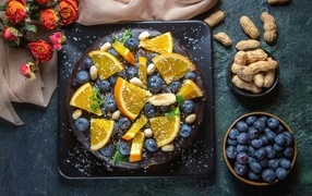 Chocolate cake with blueberries and oranges