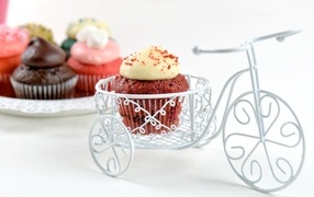 Cupcake with cream with toy bicycle