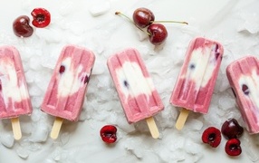 Delicious ice cream on a stick with cherries