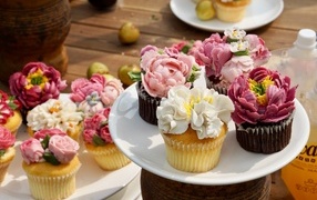 Delicious muffins with cream flowers