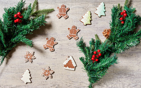Festive cookies with fir branches on the table