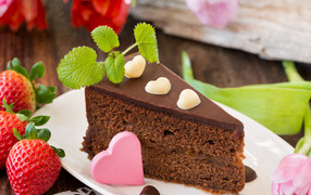 Piece of chocolate cake with strawberries and heart
