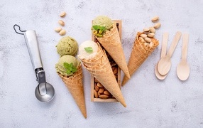 Pistachio and almond ice cream in a waffle cone