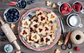 Sweet figured cookies on the table with berries