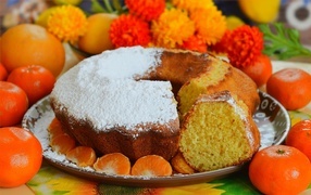 Sweet pie on the table with tangerines and oranges