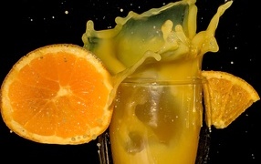 Fresh orange juice on black background