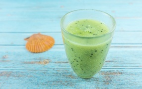 Fruit green smoothie on blue table