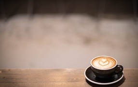 Small cup of coffee on a wooden table