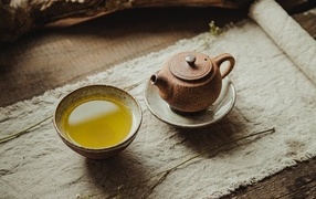 Teapot with a cup of green tea