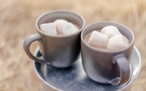 Two small cups of coffee with marshmallows