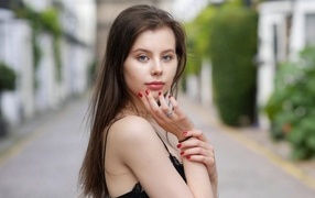 Cute blue-eyed girl with red manicure
