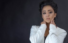 Girl in a white jacket on a gray background
