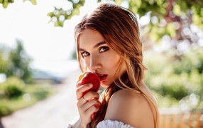 Girl with a red apple in her hand