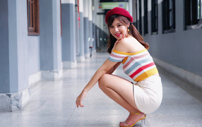 Smiling Asian woman in red beret