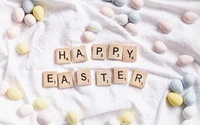 Happy Easter text and Easter eggs on the bedspread