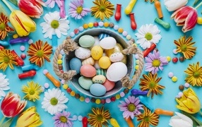 Multicolored eggs with flowers on a blue background for Easter