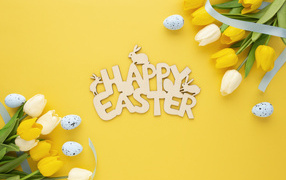 The inscription Happy Easter on a yellow background with tulips
