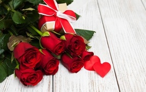 A bouquet of red roses and a gift for your beloved on March 8