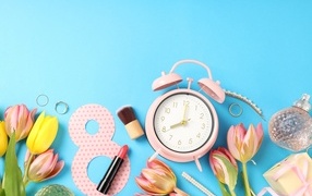 Alarm clock, flowers and decor on a blue background for March 8
