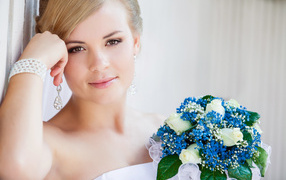 Beautiful girl bride with a blue bouquet