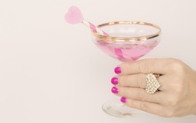 Heart-shaped ring on a girl's hand with a glass